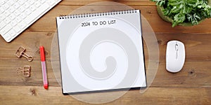 2024 to do list and on blank notebook paper background, top view