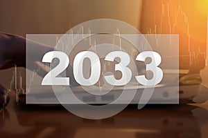 2033 digits on the background of a person working in the evening at the computer