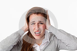 20s woman stressed by noise,covering her ears
