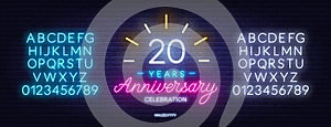 20th anniversary celebration neon sign on dark background.