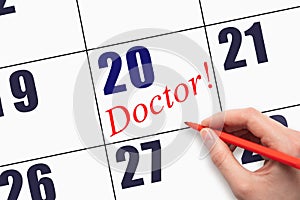 20th day of the month. Hand writing text DOCTOR on calendar date.