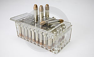 .22 caliber bullets in plastic box on white background