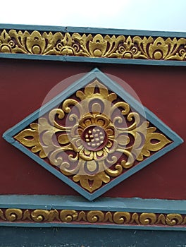 22 May 2023 : Balinese style pattern on the wall in Bali Island with gold and red Colour, Indonesia