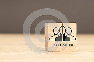 24-7 Customer support concept. Group of wooden block with Group of Call Center Workers icon