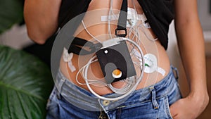 24-hour ECG monitoring and Holter monitoring on a woman body