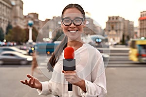 24 Hour News Source. TV reporter presenting the news outdoors. Journalism industry, live streaming concept.