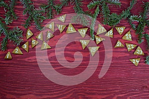 24 numbered advent cookies on red wood