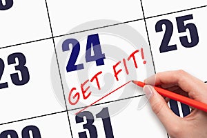 24th day of the month. Hand writing text GET FIT and drawing a line on calendar date. Save the date.