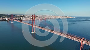 The 25 April bridge (Ponte 25 de Abril) located in Lisbon, Portugal, crossing the Targus river. Drone. 4k