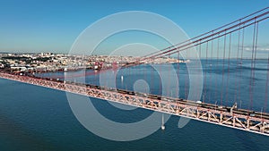 The 25 April bridge (Ponte 25 de Abril) located in Lisbon, Portugal, crossing the Targus river. Drone. 4k