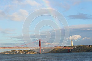 25 de abril bridge 25th of April Bridge, Lisbon, Portugal. Beautiful red suspension bridge over the sea, a rainbow