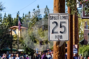 25 mph speed limit sign, attached to a wooden post