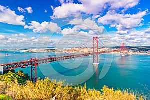 The 25th April Bridge Ponte 25 de Abril in Lisbon, Portugal. Picturesque skyline with beautiful sky