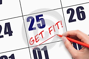 25th day of the month. Hand writing text GET FIT and drawing a line on calendar date. Save the date.