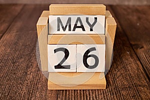 26 Mai on wooden grey cubes. Calendar cube date 26 May. Concept of date.