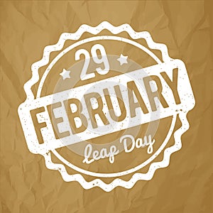 29 February Leap Day rubber stamp white on a crumpled paper brown background.