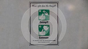 2G Corona warning sign on a store in Germany