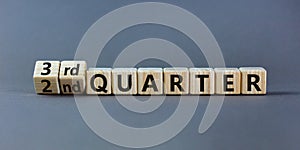 From 2nd to 3rd quater symbol. Turned wooden cubes and changed words `2nd quater` to `3rd quater`. Beautiful grey table, grey