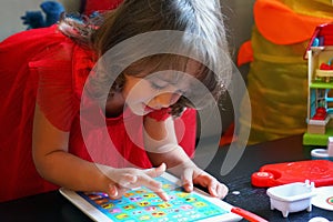 3-4 years old girl playng with her first computer