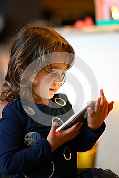 3-4 years old girl playng with her first computer