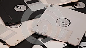 3.5 inch computer floppy disks scattered on a flat surface