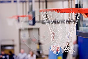 3 Basketball Hoops with nets hanging inside a gym