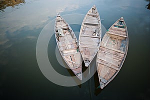 3  boats floating on calm river