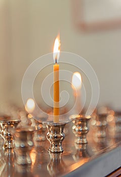 3 candles in an Orthodox church on a light
