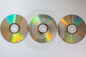 3 cd compact disks with computer drivers in a row on a white background
