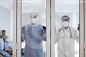 3 of Dortor, Nurse and patient looking out in the quarantine room - 19 Concept