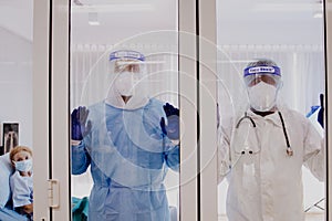 3 of Dortor, Nurse and patient looking out in the quarantine room - 19 Concept