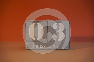 3 Februar on wooden grey cubes. Calendar cube date 03 February. Concept of date. Copy space for text. Educational cubes