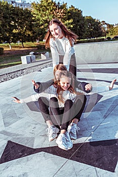 3 girls girlfriends teenagers 12-15 years old, ride skateboard, day city street, happy smile enjoy have fun after school