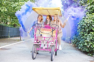 3 girls (young women) riding on a rickshaw and having fun together