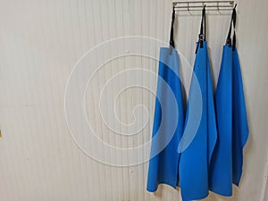 3 hanging blue aprons