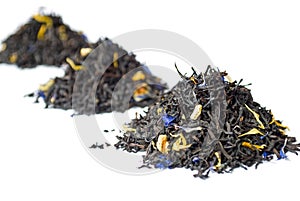 3 heaps of black Earl Grey tea isolated on white