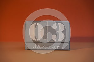 3 Januar on wooden grey cubes. Calendar cube date 03 January. Concept of date. Copy space for text. Educational cubes