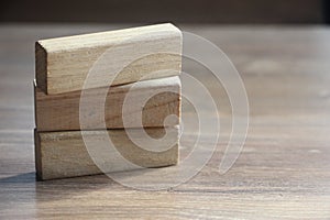 3 long wooden blocks on wooden table. Education and business concept