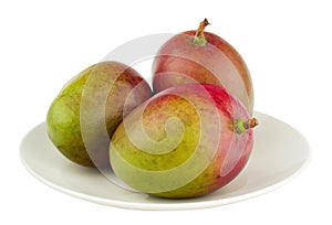 3 mangos on the white plate, isolated photo