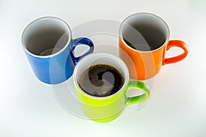 3 mugs, 1 with green coffee.