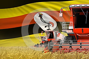 3 red modern combine harvesters with Uganda flag on wheat field - close view, farming concept - industrial 3D illustration