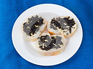 3 sandwiches with black caviar