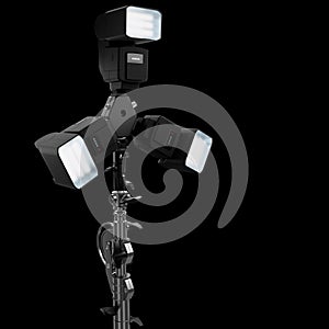 3 Speedlight flashes guns on tripod holder isolated on black background