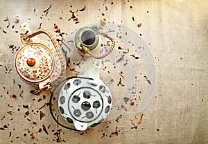 3 various traditional ceramic teapots on a canvas background
