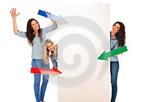 3 women pointing their arrows to a big blank board