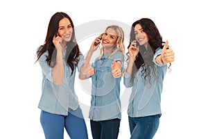 3 women talking on the phone making the ok sign