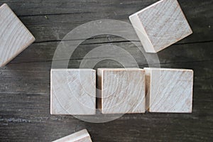 3 Wood Blocks Front View, On Wooden Table, polished wooden table background