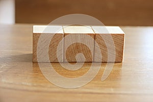 3 Wood Blocks Front View, On Wooden Table, polished wooden table background