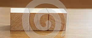 3 Wood Blocks Front View, On Wooden Table, polished wooden table background