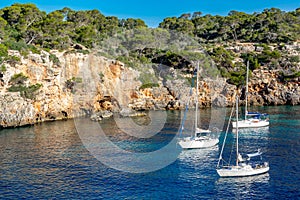 3 yachts Spain Majorca island, beautiful beach bay Cala Pi, Mediterranean Sea